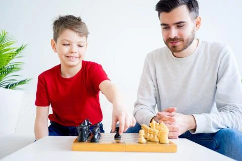 Father and son playing chess Stock Photos