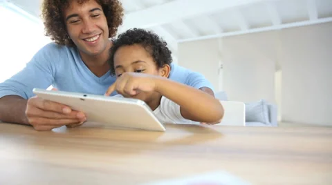 Father and son playing with digital tablet Stock Footage 37557258