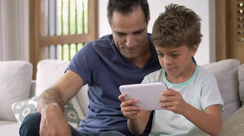 Father and son playing with digital tablet Stock Footage 57828348