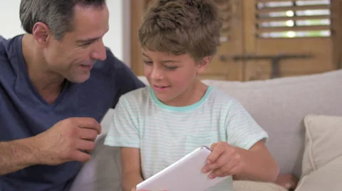 Father and son playing with digital tablet Video stock 57828411