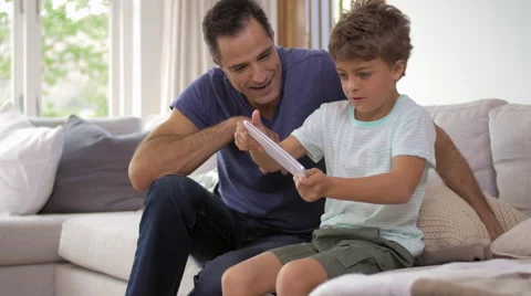 Father and son playing with digital tablet Video stock 57828493