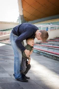 Father and son playing in empty stadium Stock Photos