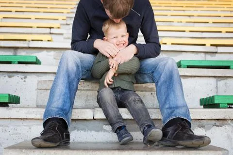 Father and son playing in empty stadium Stock Photos