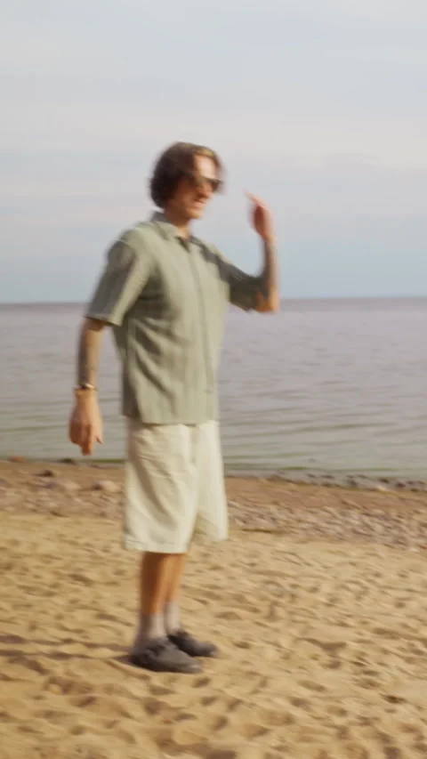 Father and Son Playing Fetch with Playful Dog on Sandy Beach Stock Footage 340265471