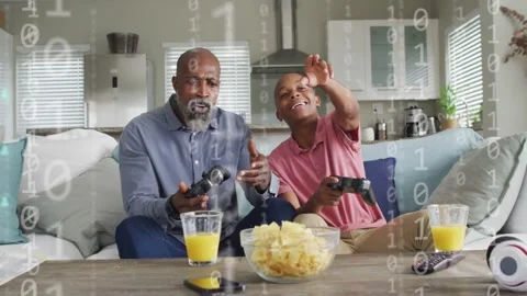 Father and son playing game, controller tap causing floating icons, both Stock Footage 333233063