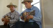 Father And Son Playing Guitar Together. Stock Footage