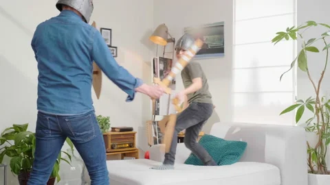 Father and son playing knight's swordfight Stock Footage 170443111