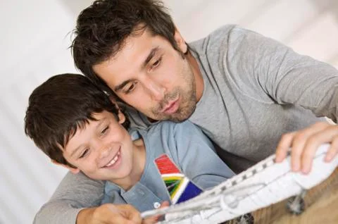Father and son playing with model aeroplane Stock Photos