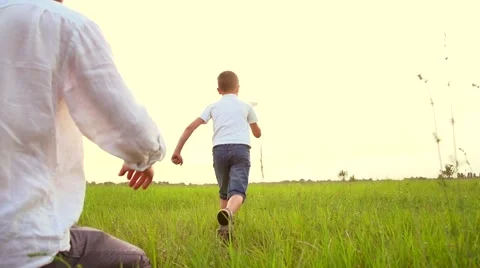 Father and son playing with paper airplane outdoors Stock Footage 59082979