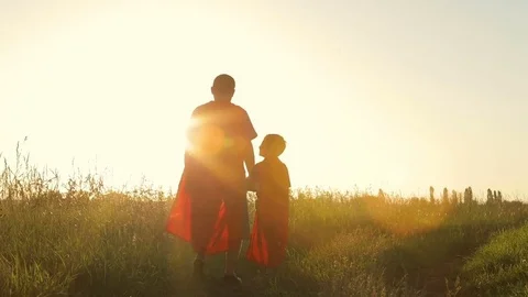 Father and son playing superhero at the sunset time. Stock Footage 79197956