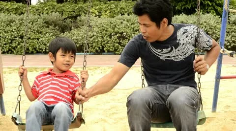 Father and Son Playing on a Swing Together Stock Footage 10849099