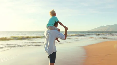 Father and Son Playing Together at the Beach at Sunset. Stock Footage 56531317