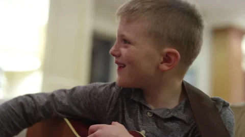 Father and son practicing on their guitars in the living room Stock-Footage 63234593