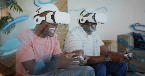 Father and son pressing start button, leaning in and playing VR game with Stock Footage 320955595