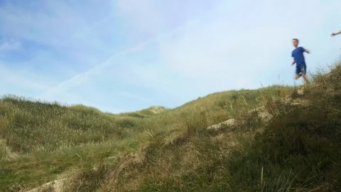 Father and son running down hill Stock Footage 79142140