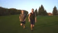 The father and a son running on the grass. slow motion 4k or 4k+ Resolution