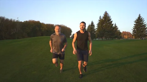 The father and a son running on the grass. slow motion Stock Footage 97724013