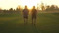 The father and a son running in the park on the sunset background. slow motion 4k or 4k+ Resolution