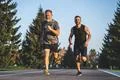 The father and a son running on the park road Photo