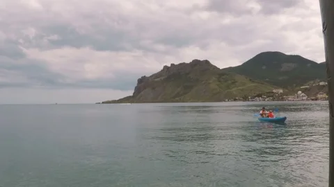 The father and son sail on a kayak Stock Footage