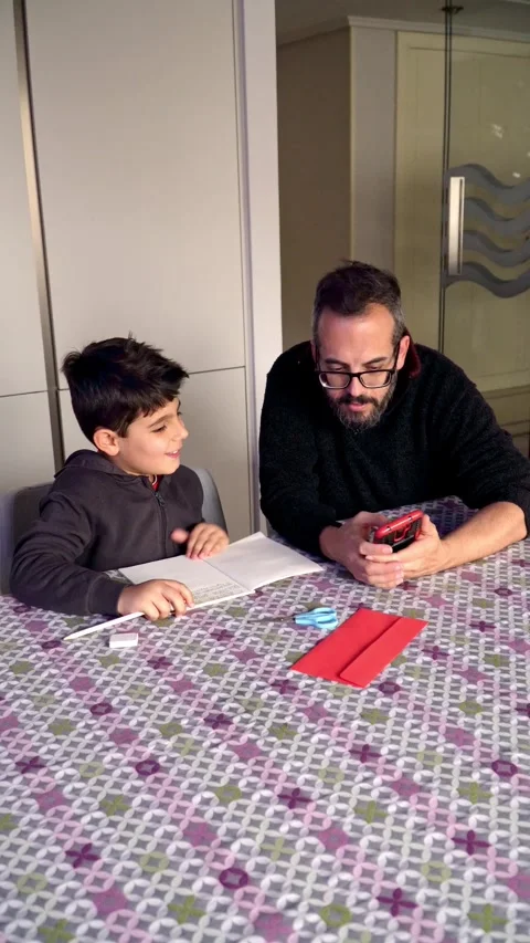 Father and son searching internet on smartphone 스톡 동영상 345253902