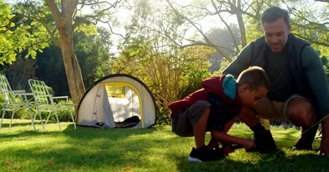 Father and son setting up a tent Stock Footage