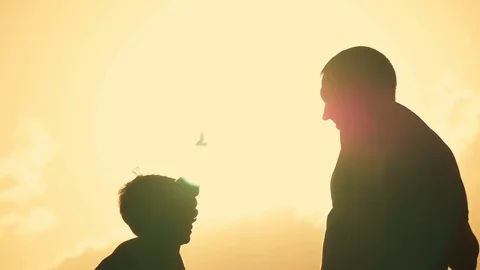 Father and son shake hands in agreement. Happy family having fun in the evening Stock Footage