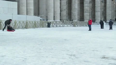 Father and son on a sled snow at St. Peter Square Stock Footage