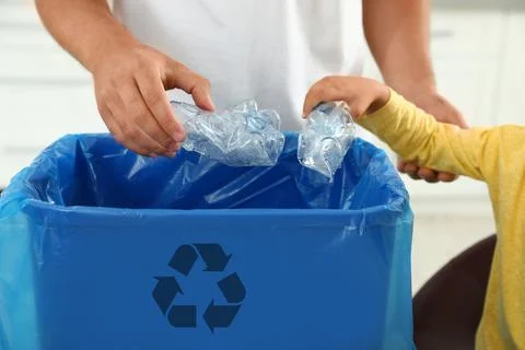 Father and son sorting garbage in kitchen, closeup. Recycling concept Stock Photos