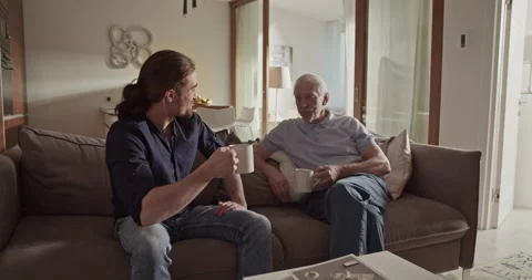 Father and son speaking on sofa Stock Footage 196236002
