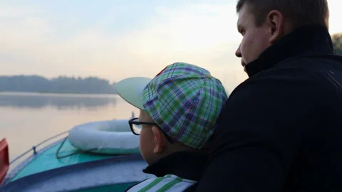 Father and son spend time together during a fast ride on a speed boat Stock-Footage 96206417