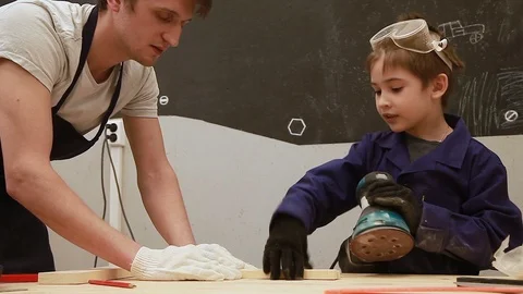 Father and son spend time together studying carpentry Stock Footage 102241489