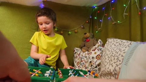 Father and son spend time together indoor by playing table football. Emotional Stock Footage 133510367