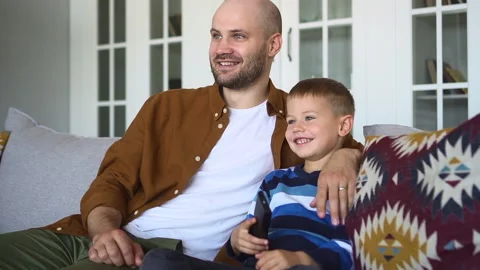Father and son spend time at home boy presses key on remote spbd Stock Footage 165590353