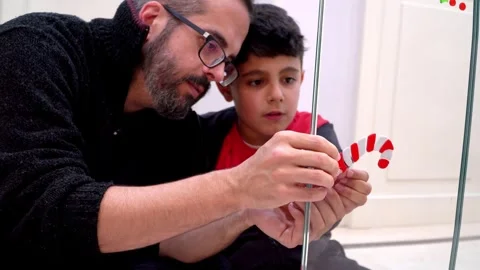 Father and son spending quality time together doing christmas crafts Stock Footage 345253168