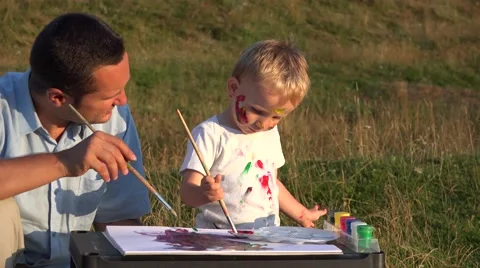 Father and son spending time together in nature. Man and child painting  Stock Footage 46212187