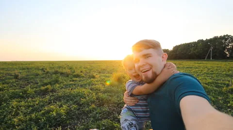 Father and son spending time together in sunny nature, taking selfies Stock Footage 51472375