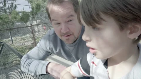Father and son spending time together talking at the zoo. Video stock 169733496