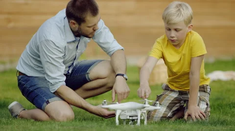 Father and son study quadrocopter drone Stock Footage 66017807