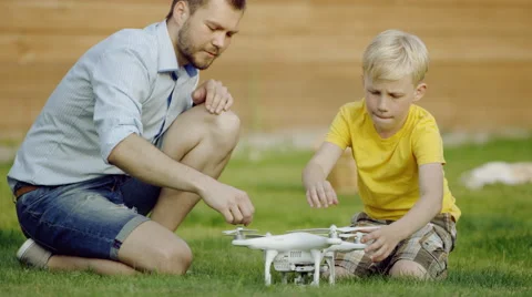 Father and son study quadrocopter drone Stock Footage 66112251
