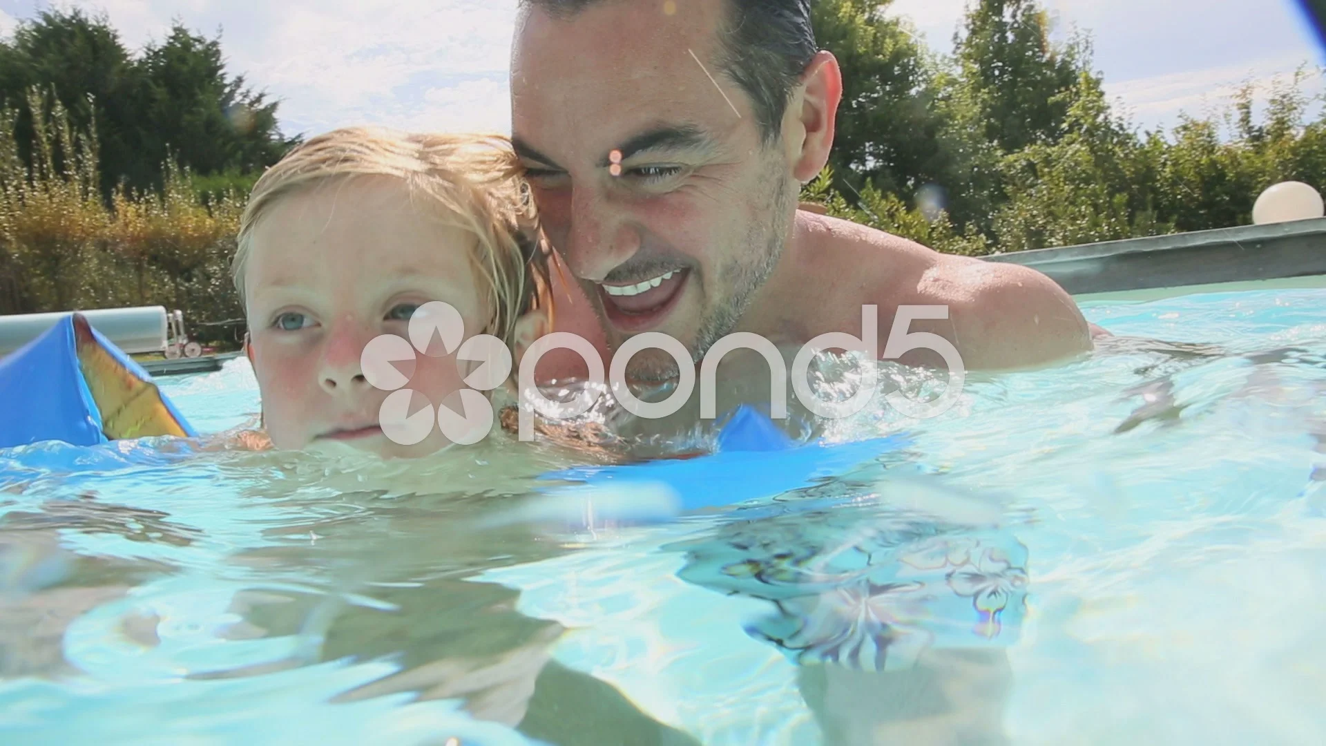 father and son in swimming pool