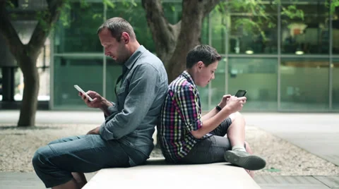 Father and son with tablet computer and smartphone in the city HD Stock Footage