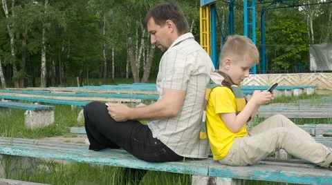 Father and son with tablet computer and smartphone Stock Footage 63424494