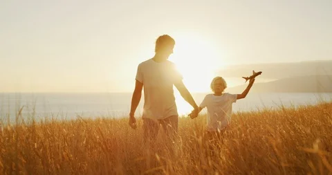Father and son take a sunset stroll Stock Footage 101398535