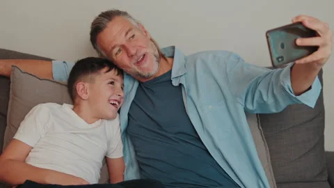 Father And Son Taking A Happy Selfie At Home Stock Footage 330494402