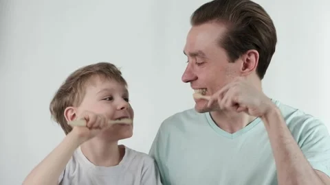 Father and son teeth brushing. Dad and his son Stock Footage 174443004