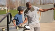 Father And Son Together At Skateboard Park Stock Footage