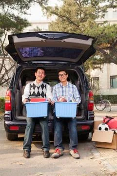 Father and son unpacking car for college Stock Photos