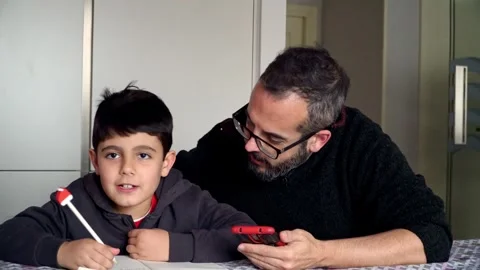 Father and son using smartphone to write the Christmas wish list 스톡 동영상 345253435