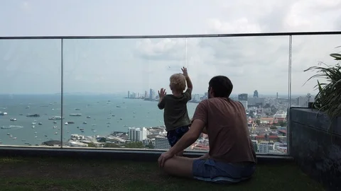  father and son on the viewing platform watching the city Stock Footage 104701683